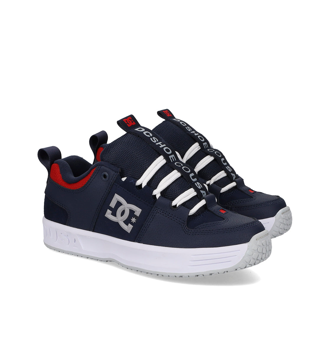 Navy blue sneakers with white soles and red accents on a white background