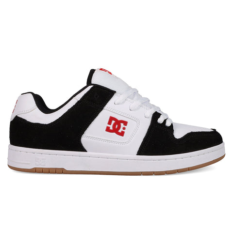 A black and white DC Shoes Men's Manteca 4 with a gum sole, white laces, red DC logo on side and tongue, plus suede accents. This low-cut sneaker offers classic style for skate or streetwear.