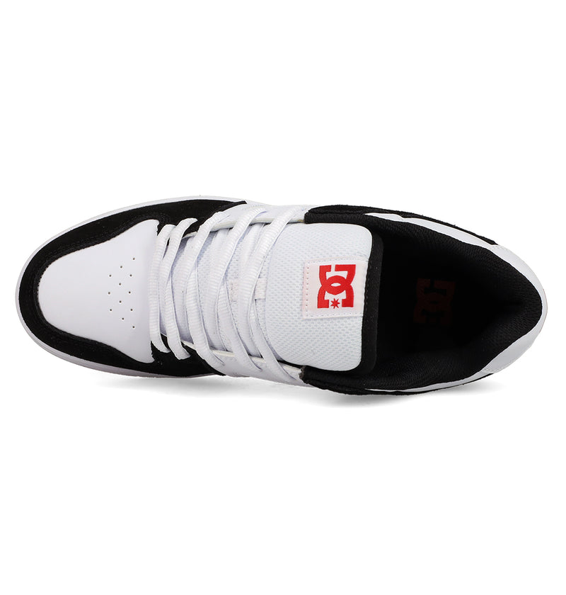 Top view of a black and white Men's Manteca 4 DC Shoes sneaker with white laces and the red DC Shoes logo on the tongue, highlighting its classic style.