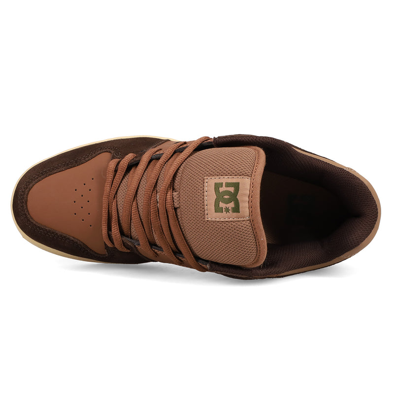 Top view of a brown and tan Men’s Manteca 4 DC Shoes sneaker with perforated toe, textured tongue, and brown laces. The classic skate shoe features the DC Shoes logo on the tongue.
