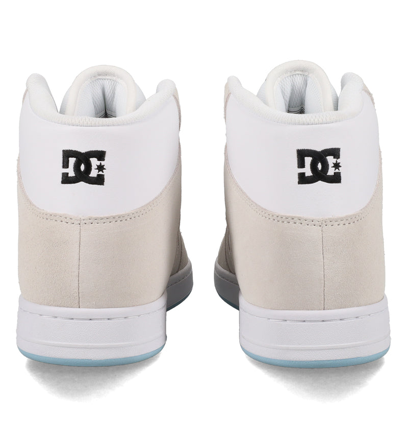 The Manteca 4 Hi by DC Shoes are high-top sneakers in light beige and white, shown from the back with a black DC Shoes logo on the heel.