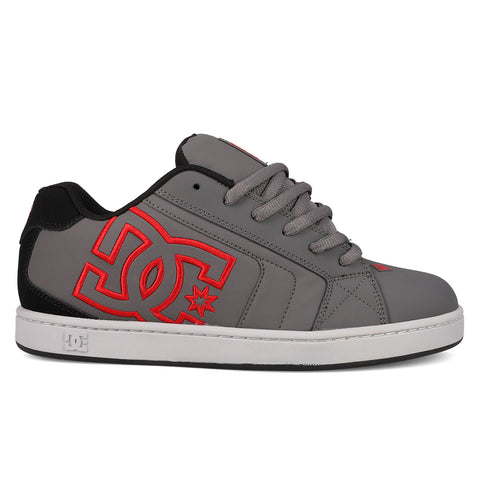 The DC Shoes Men's Net Shoes feature a durable gray upper with black heel and tongue, bold red DC logo on the side, gray laces, and a white rubber sole.