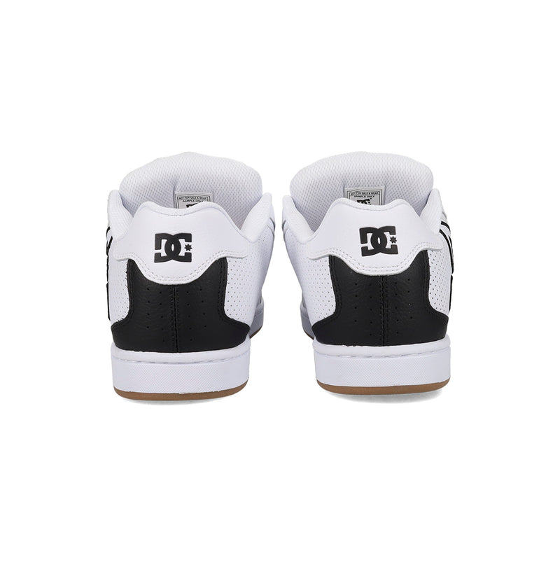 Rear view of the Men's Net Shoes by DC Shoes in black and white, featuring the DC logo on the heel and a signature puffy design for all-day comfort, set against a white background.