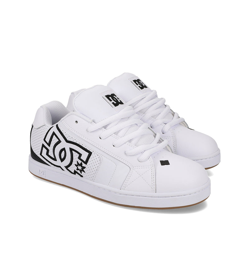 Shown on a white background, the Men's Net Shoes by DC Shoes are white sneakers with black detailing, made from durable materials and featuring a prominent DC logo on the side.
