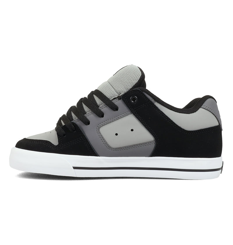 The DC Shoes Men's Pure Shoes, shown in black, gray, and white with a flat sole, thick laces, and padded tongue for comfort and versatility, are displayed from the side on a plain white background.