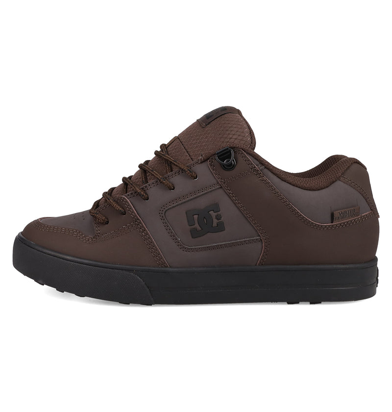 The Men's Pure Shoes by DC Shoes are brown skate shoes with a black sole and laces, featuring a prominent side DC logo. Viewed from the left, this men's shoe offers a padded tongue and heel for comfort, making it great for daily wear.