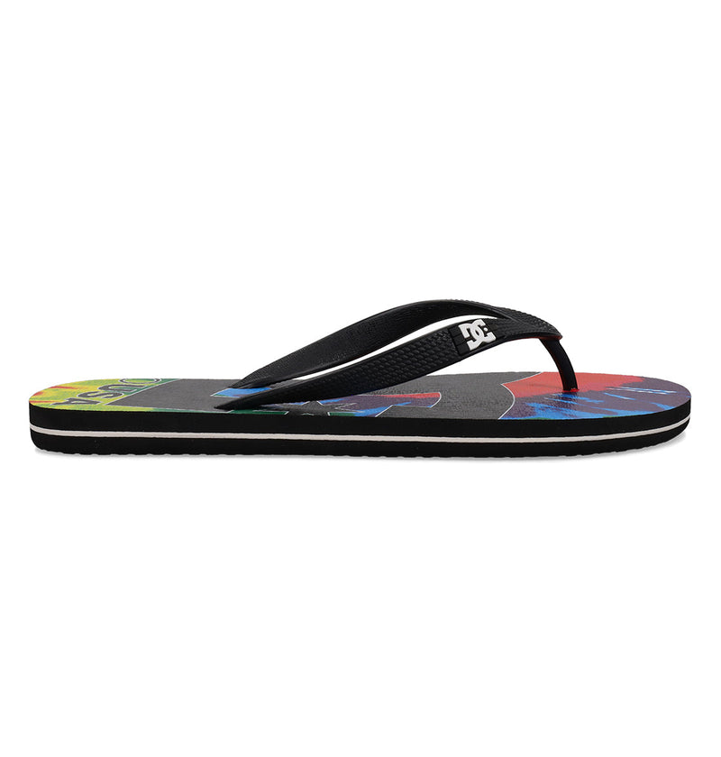 The Men's Spray Graffik Slides by DC Shoes are black slip-on sandals with a colorful sole and the DC logo on the strap, shown in side profile against a white background—ideal for comfort after a skate session.