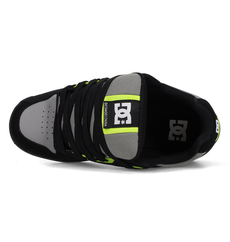 Top view of the Men's Stag Shoes by DC Shoes in black and gray with neon green accents, black laces, visible DC Shoes logos on the tongue and insole, and a durable cupsole for added support.