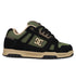 The DC Shoes Men's Stag skate shoe in black and olive green features beige accents, a side DC logo, durable cupsole, thick rubber sole, and black laces—built for long-lasting wear and true skate style.