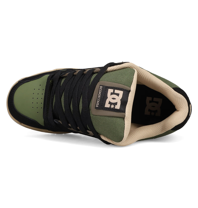 Top view of DC Shoes Men's Stag Shoes featuring a green and black technical silhouette, beige lining, black laces, perforated toe, and DC logo on the tongue.
