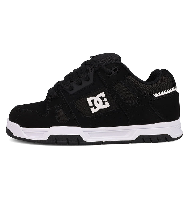 The DC Shoes Men's Stag features a black low-top design with black laces, subtle mesh and suede details, white sole, cupsole construction, and a white DC logo on the side—shown from the left.