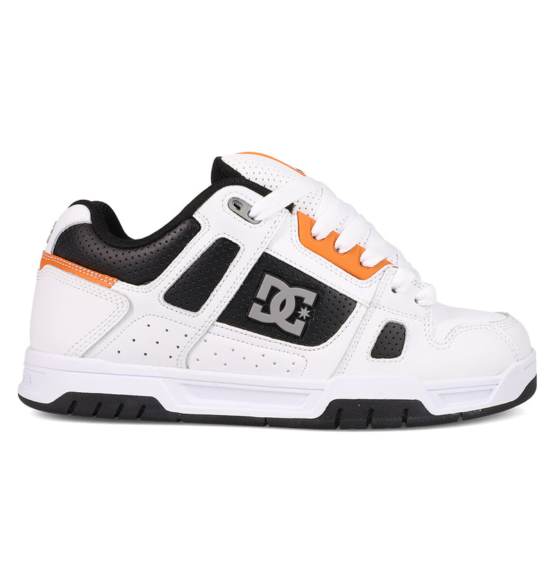 The Men's Stag Shoes by DC Shoes are white skate shoes with black and orange accents, durable cupsoles, white laces, perforated details, and a bold DC logo—ideal for showcasing authentic skate style.