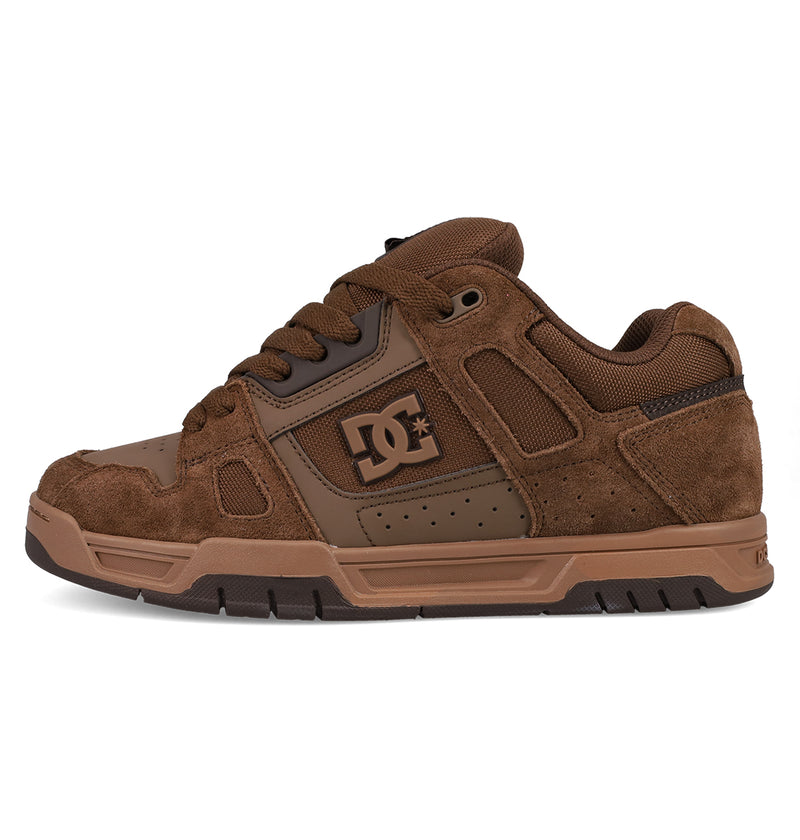 The DC Shoes Men's Stag Shoes feature a brown suede and mesh upper, thick cupsole, padded collar, and signature DC logo on the side—ideal for skate culture.