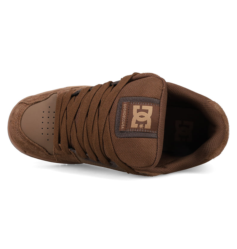 Top view of the Men's Stag Shoes by DC Shoes in brown, featuring thick laces, a padded tongue with a white DC Shoes logo, cupsole construction, and perforated toe cap for ventilation—showcasing classic skate style.