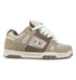The Men’s Stag Shoes by DC Shoes showcase a beige and brown color scheme with white laces and the signature DC logo on the side. Crafted from a combination of suede and mesh, these skate shoes feature an oversized puff tongue for enhanced comfort. The durable cupsole outsole comes in light beige with brown accents, making them both stylish and functional for skating.