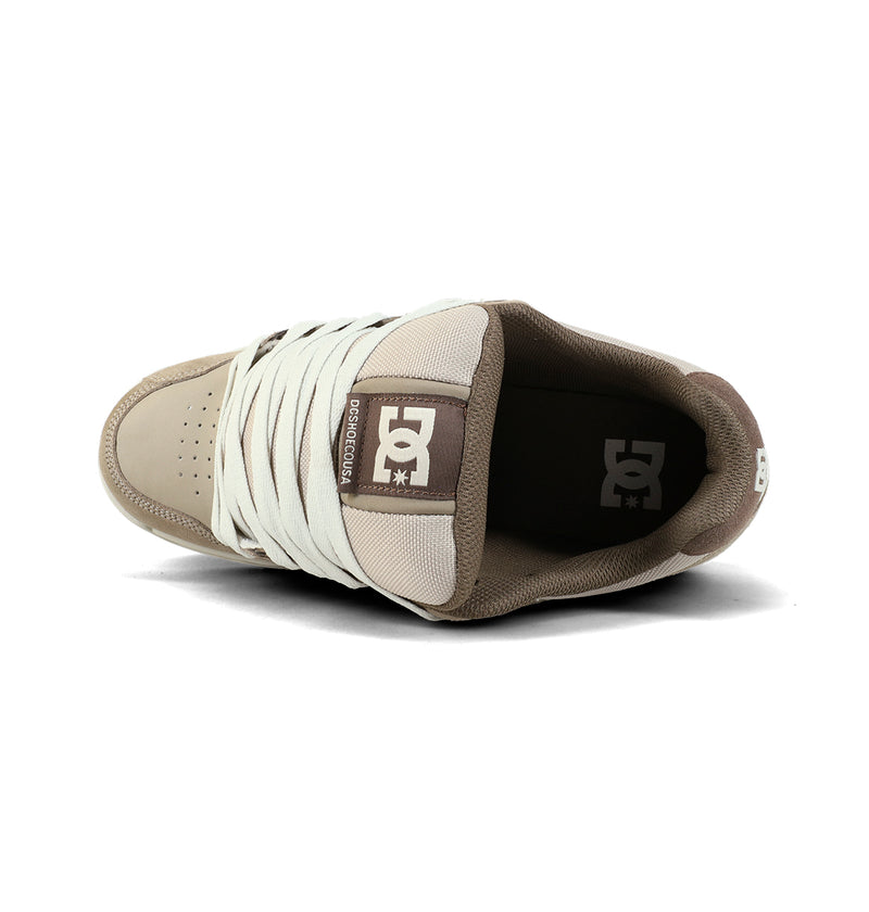 The DC Shoes Men's Stag Shoes, shown in beige and brown from above, feature an oversized puff, white laces, logo on the tongue, padded collar, and a durable cupsole for comfort.