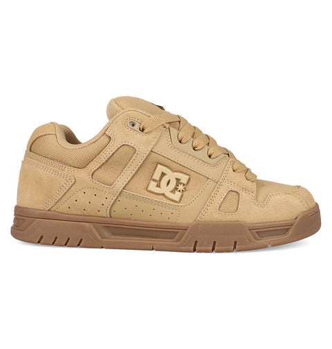 The Men's Stag Shoes by DC Shoes feature a tan and brown design, chunky cupsole, mesh and suede accents, laces, low-top profile, and signature DC logo—a stylish nod to classic skate culture.