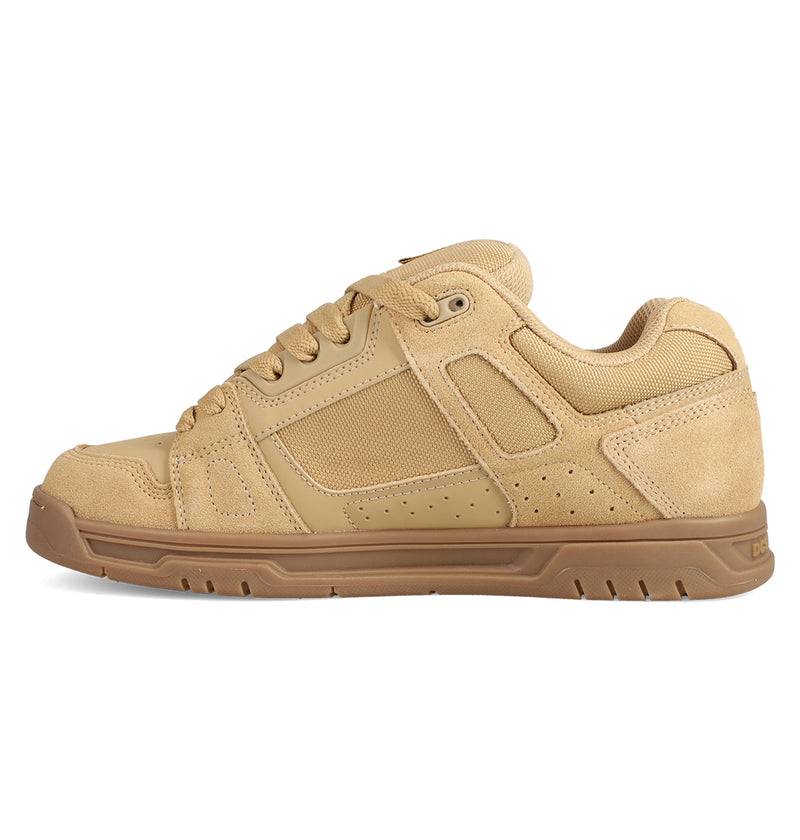 The Men's Stag Shoes by DC Shoes feature a tan skate-inspired design with a brown rubber cupsole, mesh and suede panels, visible stitching, and lace-up closure. Displayed in a left side profile view.