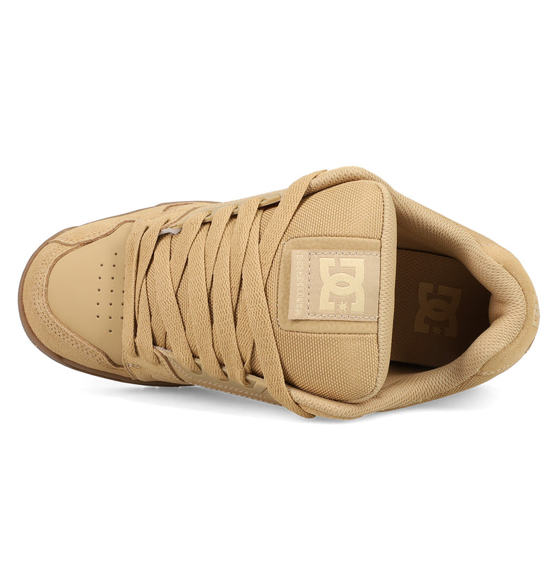 The DC Shoes Men's Stag Shoes in tan are shown from above, featuring matching laces, a padded tongue with the DC logo, cupsole construction, and toe perforations inspired by classic skate style.