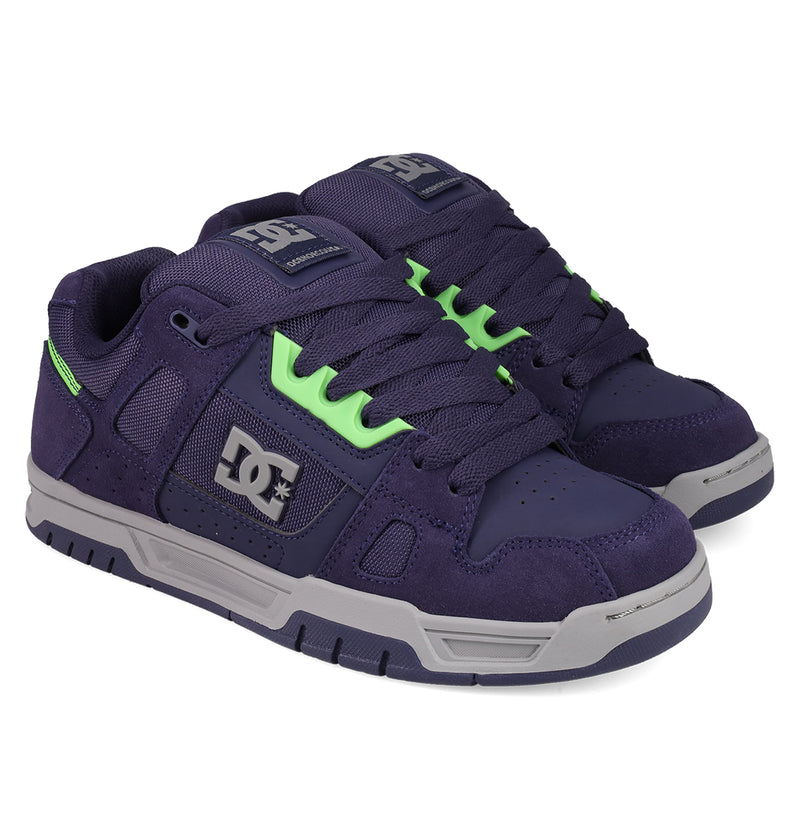 Step out in style with the Men's Stag Shoes by DC Shoes, featuring a dark purple design, neon green laces and details, white logos, sturdy cupsole construction, and grey rubber soles—ideal for skate culture vibes.
