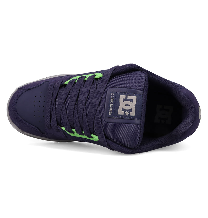 Top view of Men's Stag Shoes by DC Shoes in dark purple with neon green laces, perforated toe, cupsole construction, and a DC Shoes logo patch on the tongue for a bold skate-inspired style.
