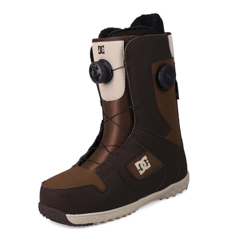 A pair of DC Shoes Women's Phase BOA® Pro Snowboard Boots in brown and beige, featuring black laces, a BOA dial system, PrimaLoft insulation, and a rugged sole, displayed against a white background.