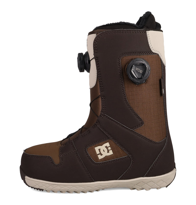 The DC Shoes Women's Phase BOA® Pro Snowboard Boots in brown and beige are shown in a side profile against a white background, featuring the Phase BOA® Pro black dial tightening system, PrimaLoft insulation for enhanced warmth, and the DC logo on the side.