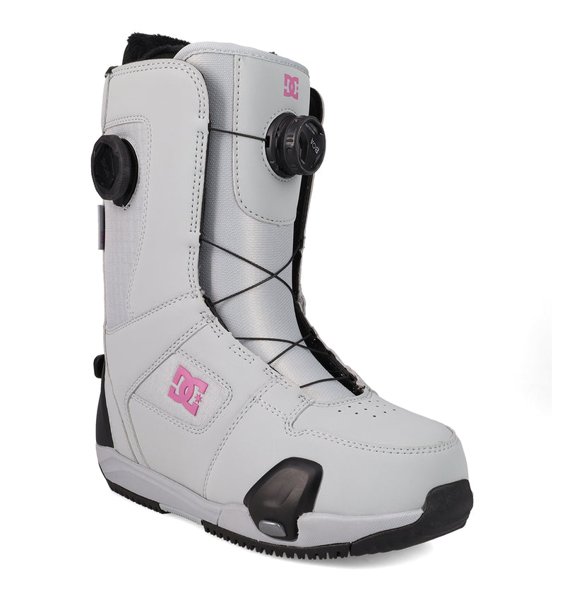 The DC Shoes Women's Phase BOA® Pro Step On® Snowboard Boot comes in white with black accents and a pink DC logo. It features the BOA Fit System for easy lacing, reinforced toe and heel areas, PrimaLoft insulation for extra warmth, and a high-top design that offers enhanced ankle support.