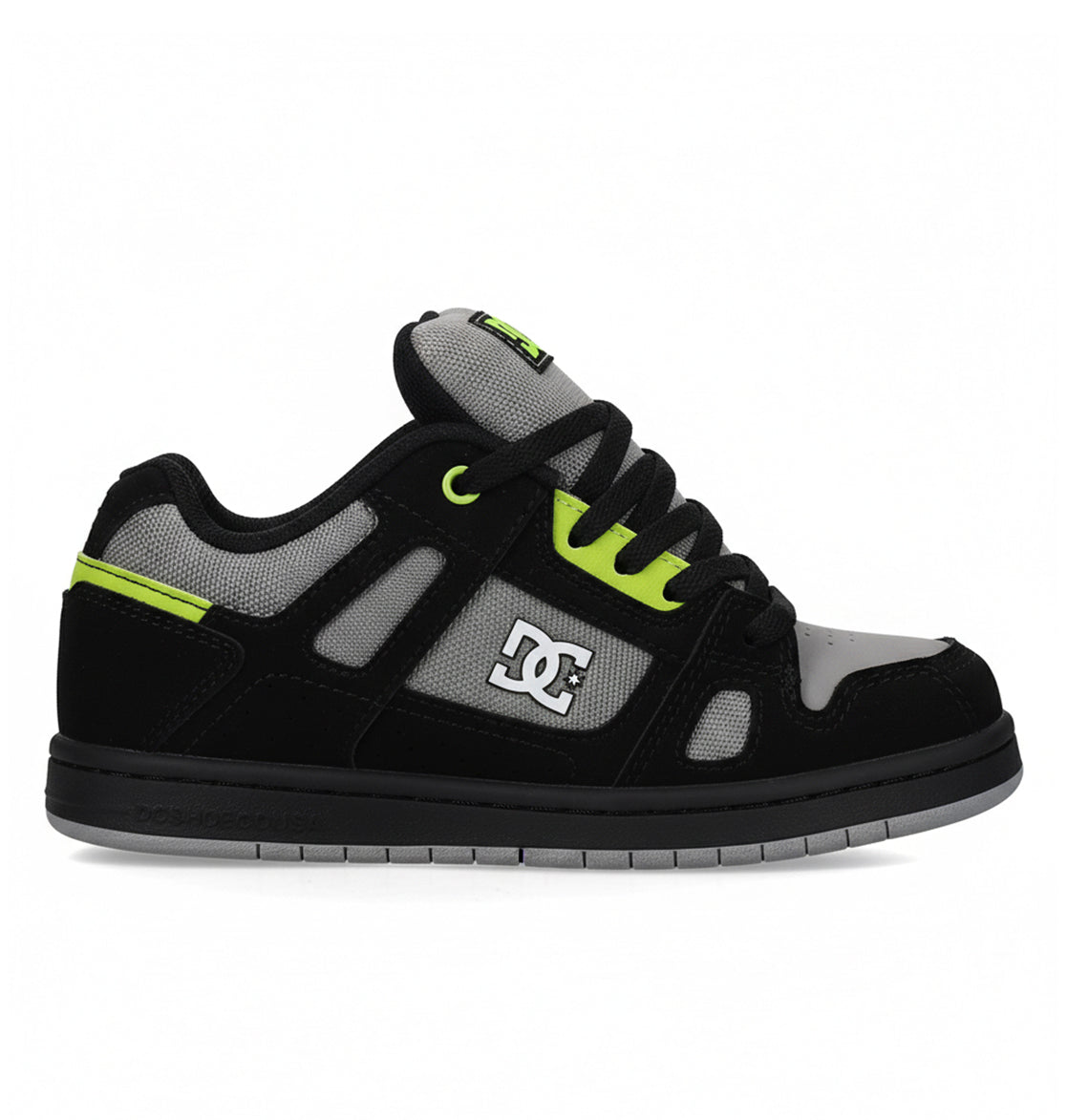 The DC Shoes Kids' Stag is a low-top skate shoe in black, grey, and neon green with a minimal silhouette, thick sole, mesh detailing, black laces, and the DC Shoes logo—perfect for everyday wear.