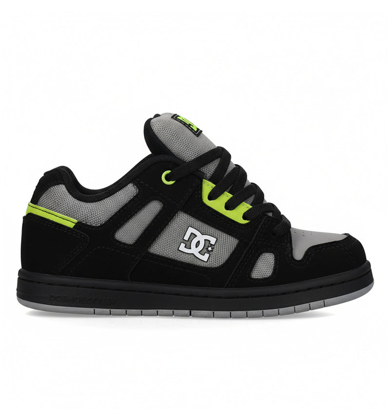 The DC Shoes Kids' Stag is a low-top skate shoe in black, grey, and neon green with a minimal silhouette, thick sole, mesh detailing, black laces, and the DC Shoes logo—perfect for everyday wear.