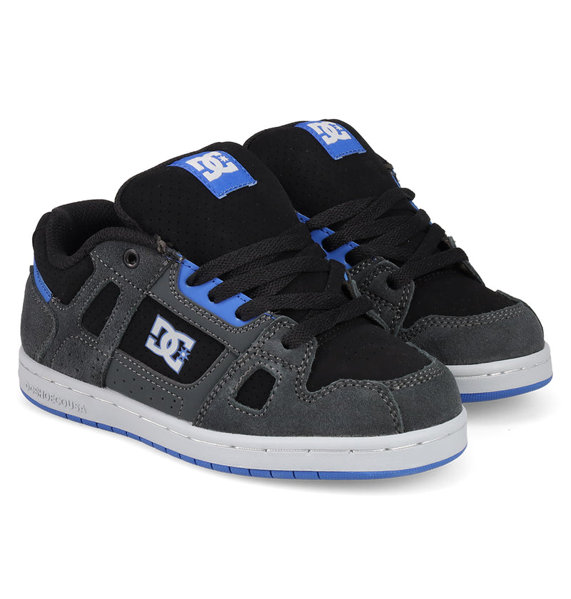 DC Shoes Kids' Stag Skate Shoes in black, grey, and blue feature white soles, blue accents, cupsole construction, and DC branding on the side and tongue.