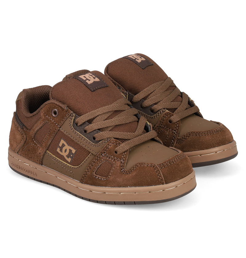 A pair of Kids' Stag Shoes by DC Shoes in brown with tan details, thick laces, and DC logos on the side and tongue, feature cupsole construction and classic skate style, displayed side by side on a white background.