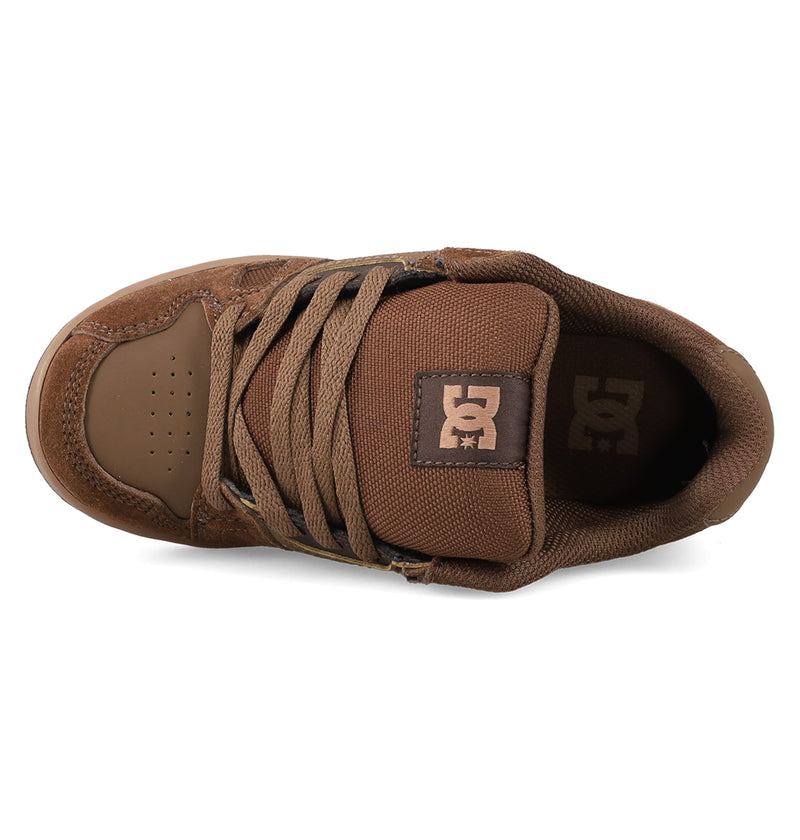 Top view of the Kids' Stag Shoes by DC Shoes, showing brown laces, a padded tongue with the DC logo, perforated toe area, and durable cupsole construction—a staple for young skaters.