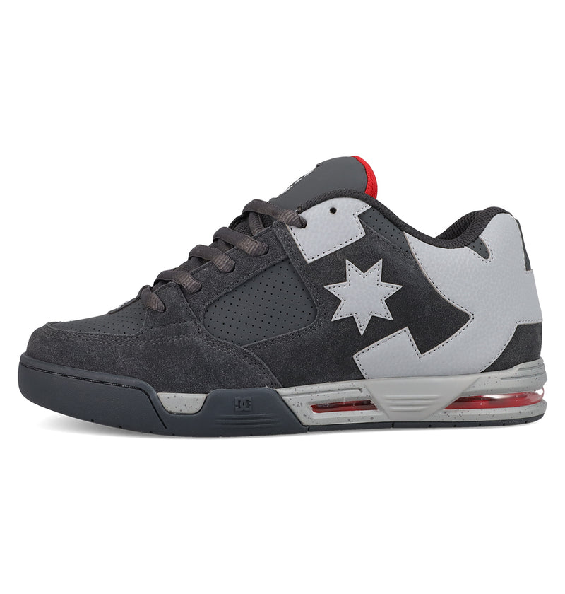 The Men's DC Command Shoes by DC Shoes feature a black and gray design with a white star and lightning bolt on the side, red accents on the tongue and sole, perforations near the laces, and embody true skate heritage for street style.