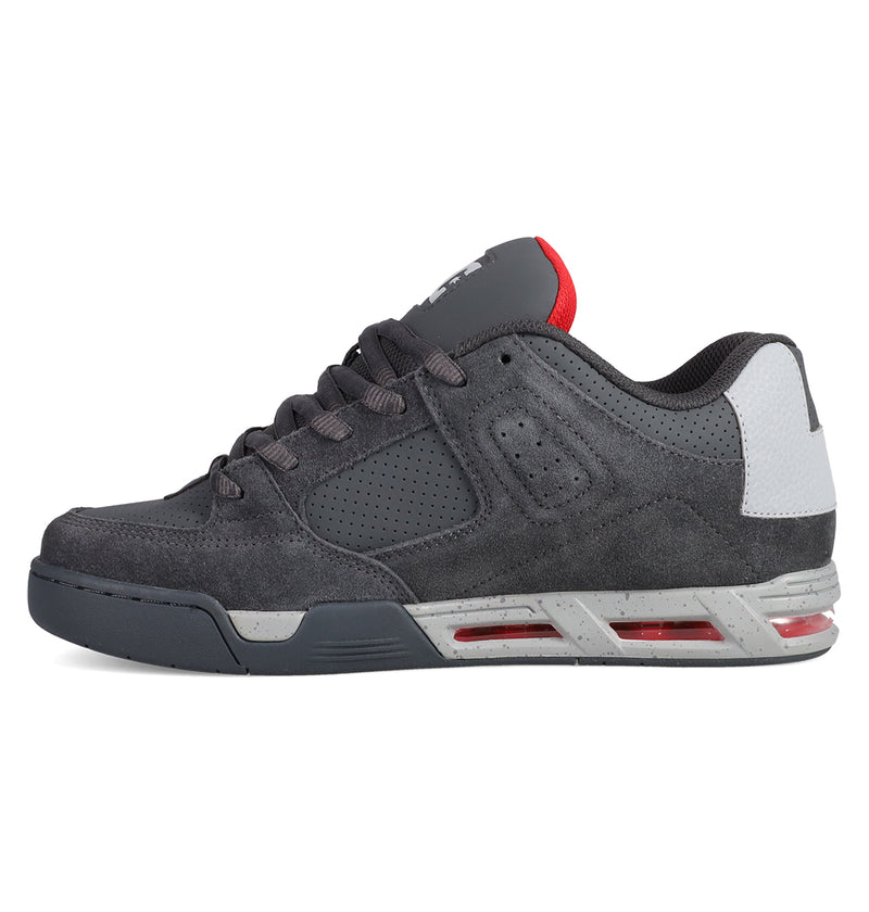 A side view of the Men's DC Command Shoes by DC Shoes in dark gray with red accents, white heel, perforated details, speckled midsole, and lace-up low-top design inspired by skate heritage.