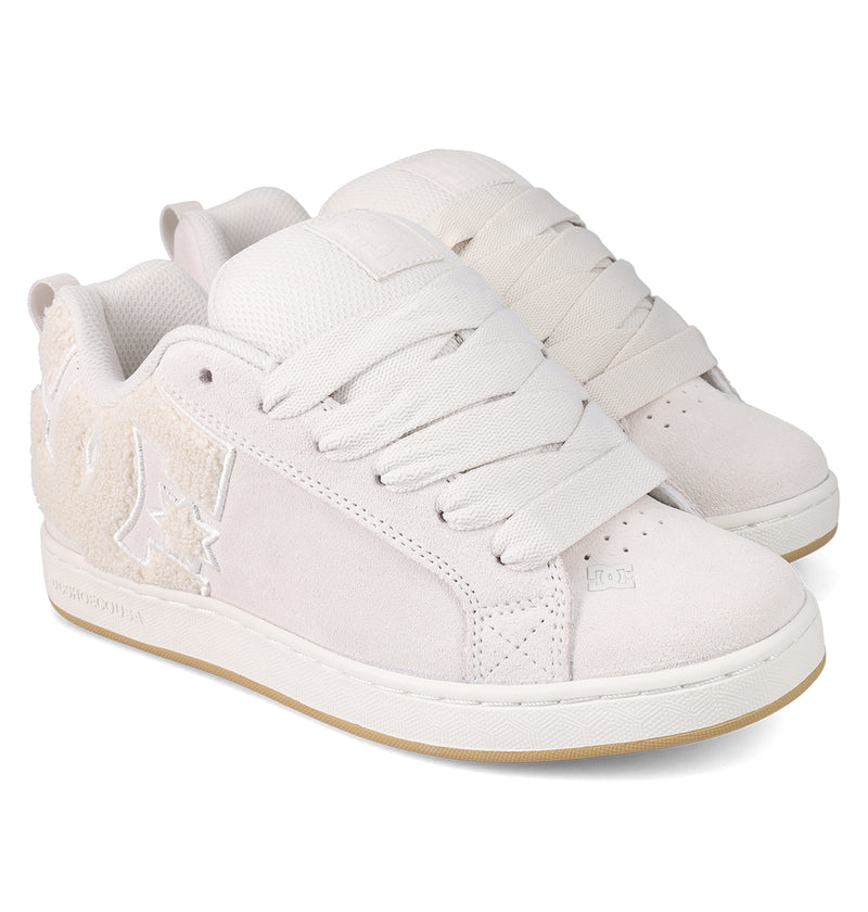 The Women's Court Graffik SD Shoes by DC Shoes feature an off-white suede upper, thick laces, textured side panels, a puffy silhouette, a light tan rubber sole, and modern stitched branding for casual style.