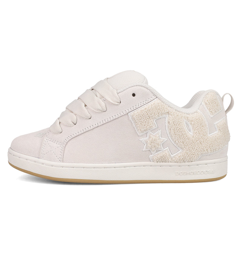The DC Shoes Women's Court Graffik SD features a cream suede upper, thick laces, a large textured DC logo, and a light tan sole. Its puffy silhouette delivers minimalist yet stylish vibes in on-trend colorways.