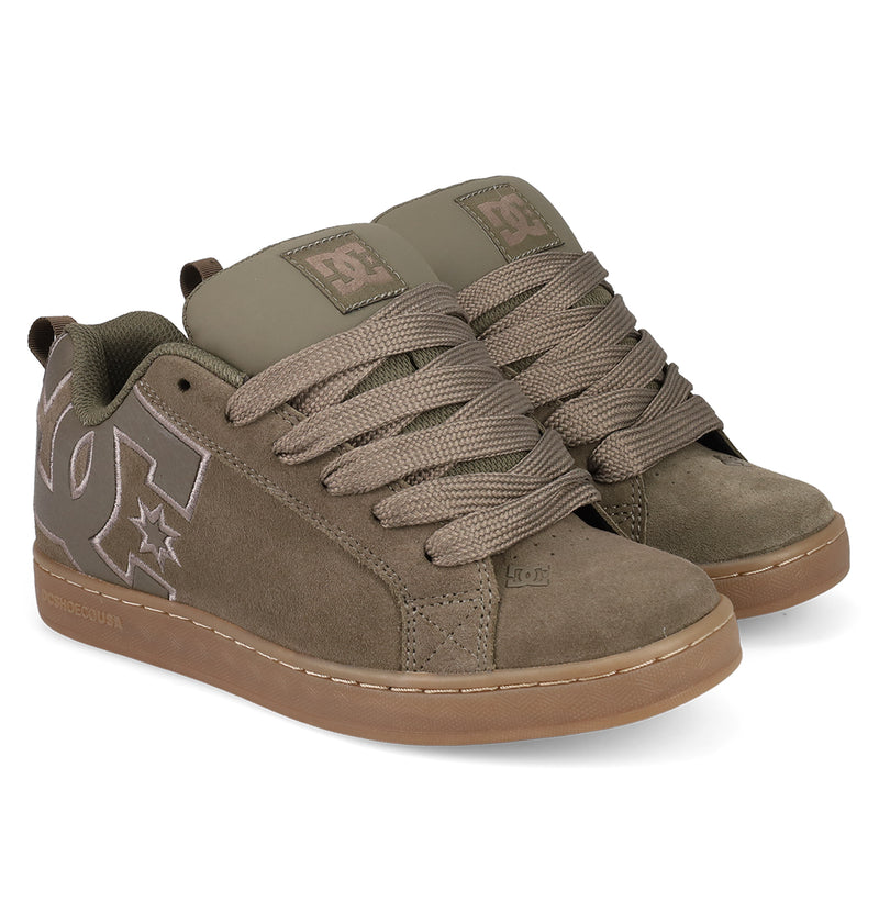 A pair of Women's Court Graffik SD Shoes by DC Shoes in olive green, featuring a puffy silhouette, thick laces, suede and leather accents, a light brown rubber sole, and prominent DC logos on the side and tongue.
