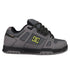 The DC Shoes Men's Stag features a gray upper with black accents, perforated details, black laces with white specks, and a black-and-yellow DC logo. It has a chunky silhouette, durable cupsole, and a black and gray sole for true skate style.