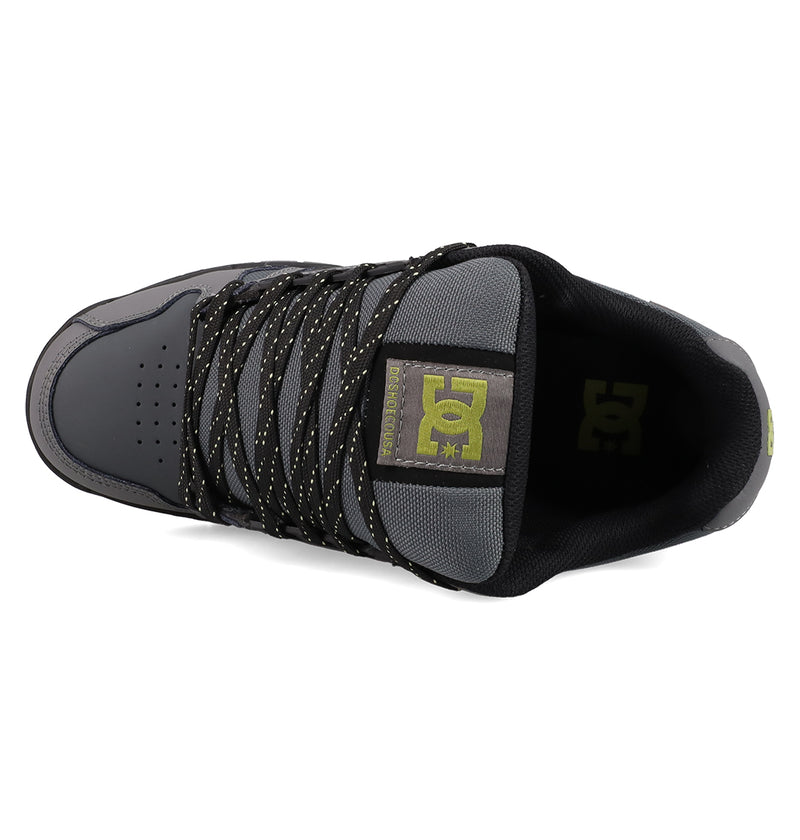 Top view of a gray and black Men's Stag Shoe by DC Shoes featuring black and yellow speckled laces, a padded black collar, yellow logo on the tongue, and a durable cupsole for lasting skate-inspired wear.