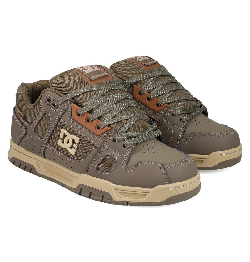 DC Shoes Men's Stag Shoes in brown and beige feature thick patterned laces, a chunky cupsole, DC logos on the side and tongue, and toe box perforations for breathability—ideal for skate culture enthusiasts.