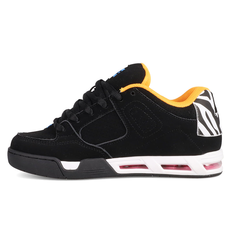 The Women's DC Command Shoes by DC Shoes are black low-top sneakers with a yellow inner lining, featuring a street-style design, pink-accented white midsole, zebra-print heel detail, black laces, and a flat sole inspired by classic skate heritage.