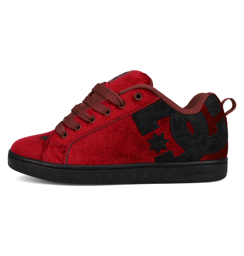 The DC Shoes Women's Court Graffik LE Shoe features red suede, a puffy silhouette, dark red laces, a black sole, and a bold black DC Shoes logo on the side.
