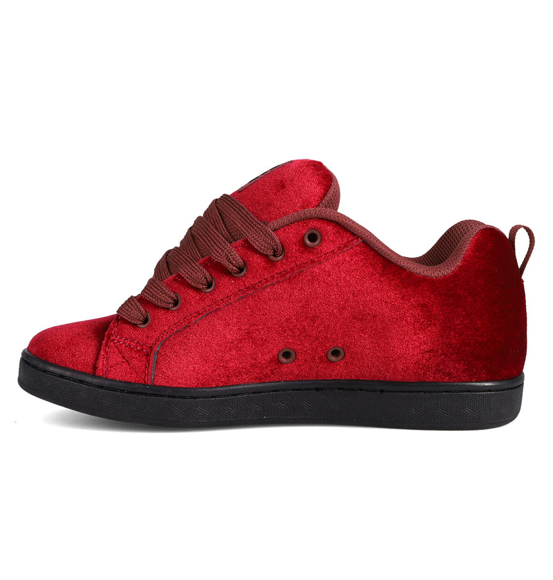 The DC Shoes Women's Court Graffik LE Shoes feature a premium red suede upper, matching red laces, a brown inner lining, and a black rubber sole, showcased from the side on a plain white background.