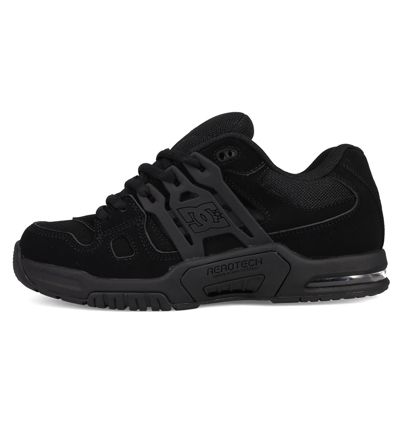 The DC Shoes Men's AT-2 features a black mesh and synthetic upper, chunky airband outsole, AGROTECH branding on the midsole, and cushioned impact support, shown from the side on a white background.