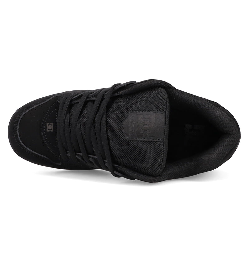 Top view of the DC Shoes Men's AT-2 Shoes in black, featuring black laces, a padded tongue, mesh-textured upper with AEROTECH ventilation, and small embossed DC Shoes logos near the toe and on the tongue.