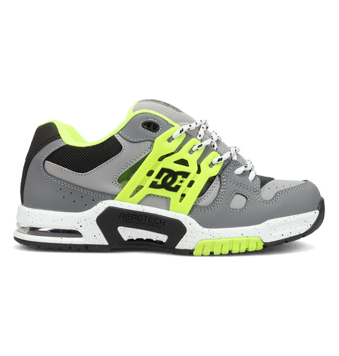 The DC Shoes Men's AT-2 features a gray and neon yellow design with black and white accents, thick sole, mesh panels, side DC logo, supportive TPU cage for stability, perforations for breathability, and a lace-up closure.