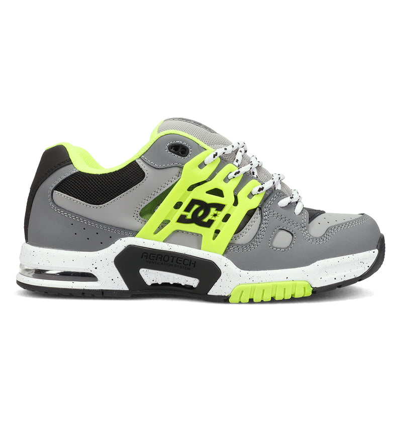 The DC Shoes Men's AT-2 features a gray and neon yellow design with black and white accents, thick sole, mesh panels, side DC logo, supportive TPU cage for stability, perforations for breathability, and a lace-up closure.