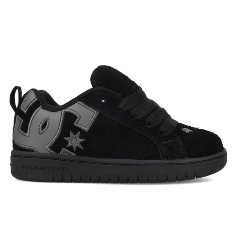The Kids' Court Graffik Special Edition Shoes by DC Shoes are black suede skate shoes with thick black laces, a low profile, a large dark gray DC logo on the side, and a black sole.