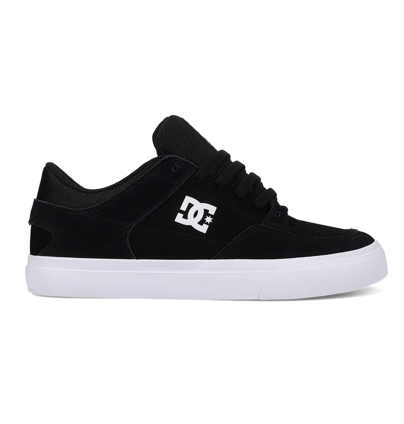 The DC Shoes Men's Onyx Shoes feature a black upper with a white DC logo, black laces, and a thick white rubber sole. This minimal vulc silhouette is shown in side profile on a white background—perfect for everyday wear.